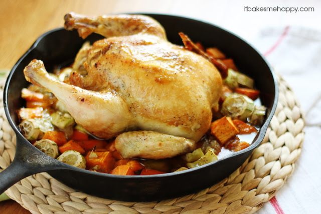 a whole chicken with veggies in a cast iron skillet 