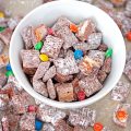 Deliciously addictive Halloween Candy Muddy Buddies comes together in minutes and is a great way to use up all that leftover Halloween candy!