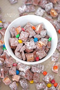 Deliciously addictive Halloween Candy Muddy Buddies comes together in minutes and is a great way to use up all that leftover Halloween candy!